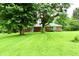 Spacious backyard featuring a lush lawn, mature trees and patio at 12087 N Gasburg Rd, Mooresville, IN 46158