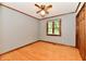 Bedroom features a ceiling fan, wood floors, a window with blinds, neutral colored walls and wood trim at 12087 N Gasburg Rd, Mooresville, IN 46158
