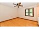 A bedroom that features hardwood floors, a ceiling fan, a window with blinds, and neutral colored walls at 12087 N Gasburg Rd, Mooresville, IN 46158