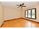 Bedroom features a ceiling fan, hardwood floors, a window with blinds and neutral-colored walls at 12087 N Gasburg Rd, Mooresville, IN 46158