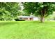 Charming ranch-style home with a brick exterior and attached garage, nestled on a lush green lawn at 12087 N Gasburg Rd, Mooresville, IN 46158