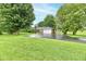 Well-maintained ranch-style house with an attached garage, surrounded by mature trees and a green yard at 12087 N Gasburg Rd, Mooresville, IN 46158