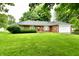 Charming brick ranch home with an attached garage and lush green lawn at 12087 N Gasburg Rd, Mooresville, IN 46158