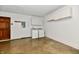 Garage featuring a door, washer/dryer, overhead storage, and concrete floors at 12087 N Gasburg Rd, Mooresville, IN 46158
