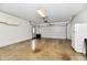 An empty two car garage with white walls, cabinets and overhead storage at 12087 N Gasburg Rd, Mooresville, IN 46158