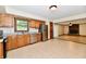 Bright eat-in kitchen with stainless appliances and wood cabinetry, and an adjacent living room with a fireplace at 12087 N Gasburg Rd, Mooresville, IN 46158