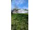 Lush green backyard with a detached two-car garage and mature trees, providing privacy at 1254 S Leland Ave, Indianapolis, IN 46203