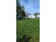 A spacious backyard featuring lush green grass and a detached two-car garage at 1254 S Leland Ave, Indianapolis, IN 46203