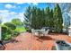 Paver patio with outdoor dining set and manicured greenery at 12605 Branford St, Carmel, IN 46032
