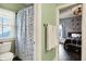 Bathroom with a polka dot shower curtain and view to bedroom at 12605 Branford St, Carmel, IN 46032