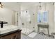 Bright bathroom featuring walk-in shower, stylish vanity, and patterned tile flooring at 12605 Branford St, Carmel, IN 46032