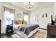 Inviting bedroom features stylish decor, natural light, and modern chandelier at 12605 Branford St, Carmel, IN 46032