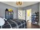 Gray bedroom with a black and white bedspread and adjacent bath at 12605 Branford St, Carmel, IN 46032