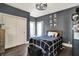 Bedroom with a black and white bedspread and dark gray walls at 12605 Branford St, Carmel, IN 46032