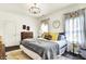 Light-filled bedroom featuring stylish furnishings, hardwood floors, and modern light fixture at 12605 Branford St, Carmel, IN 46032
