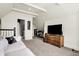 Bonus room with a plush sofa, tv, dresser, and small desk at 12605 Branford St, Carmel, IN 46032