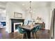 Elegant dining room featuring a fireplace, modern chandelier, and seating for six at 12605 Branford St, Carmel, IN 46032