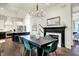 Open-concept dining area with a fireplace, seamlessly connected to the kitchen at 12605 Branford St, Carmel, IN 46032
