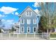 This two-story home boasts blue siding, white trim, and a classic white picket fence at 12605 Branford St, Carmel, IN 46032