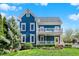 Charming blue two-story home with a bright yellow front door, white trim, and well-manicured lawn at 12605 Branford St, Carmel, IN 46032