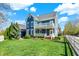 Charming blue two-story home features a large front yard, a yellow front door, and white trim at 12605 Branford St, Carmel, IN 46032