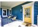Inviting front porch with seating, a patterned rug, and a bright yellow door, exuding curb appeal and charm at 12605 Branford St, Carmel, IN 46032