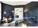 Sleek home office with dark walls, glass-top desk, comfortable seating, and modern lighting fixtures at 12605 Branford St, Carmel, IN 46032