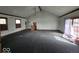 This living room has a vaulted ceiling, multiple windows, and a sliding glass door at 1354 Roache St, Indianapolis, IN 46208