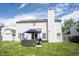 Spacious backyard features patio furniture, a barbecue grill, and a well-manicured lawn at 14153 Jasmine Ct, Fishers, IN 46038