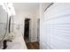 Modern bathroom featuring dual vanity with wood cabinets, stylish mirrors, and shower with patterned curtain at 14153 Jasmine Ct, Fishers, IN 46038