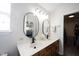 Bathroom with a dual-sink vanity, modern mirrors, and an adjacent closet and bedroom at 14153 Jasmine Ct, Fishers, IN 46038