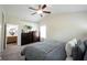 Well-lit bedroom with ceiling fan, vaulted ceiling, and view of en-suite bathroom at 14153 Jasmine Ct, Fishers, IN 46038