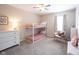 Bright bedroom featuring a bunk bed, soft carpet, and a cozy seating area near a window at 14153 Jasmine Ct, Fishers, IN 46038