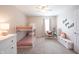 Comfortable bedroom with a bunk bed, soft carpet, and a stylish chair beside a well-lit window at 14153 Jasmine Ct, Fishers, IN 46038