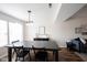 Open dining area with modern black table and seating, bright natural light, and stylish decor at 14153 Jasmine Ct, Fishers, IN 46038