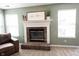 Close-up of a brick fireplace with a decorative mantle and hearth at 14153 Jasmine Ct, Fishers, IN 46038