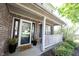 Inviting front porch with brick decor, black accents, potted plants, and a welcoming doormat at 14153 Jasmine Ct, Fishers, IN 46038