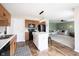 Open kitchen with wood cabinetry, a center island, and views to living area with a fireplace at 14153 Jasmine Ct, Fishers, IN 46038