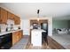 Eat-in kitchen with wood cabinets, an island with seating, and a view into the living room at 14153 Jasmine Ct, Fishers, IN 46038