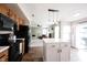 Open-concept kitchen with stainless steel appliances, a center island, and a view into the living room at 14153 Jasmine Ct, Fishers, IN 46038