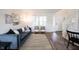 Open-concept living room featuring contemporary furnishings, stylish decor, and hardwood floors at 14153 Jasmine Ct, Fishers, IN 46038