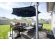 Back patio featuring comfortable outdoor seating, a grill, and a large shade umbrella at 14153 Jasmine Ct, Fishers, IN 46038