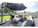 Outdoor patio area with comfortable seating, a grill, and a large umbrella for shade at 14153 Jasmine Ct, Fishers, IN 46038