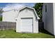 Exterior view of a white shed with a roll-up door, providing ample storage space at 14153 Jasmine Ct, Fishers, IN 46038
