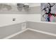 Laundry room with neutral tones, ample wall storage, and modern artwork at 15400 Manderley St, Fishers, IN 46040