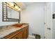 Bathroom with brown vessel sink, decorative mirror, and wooden vanity at 162 Carmelaire Dr, Carmel, IN 46032