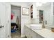 Bathroom featuring granite countertop, modern bowl sink, and walk-in closet at 162 Carmelaire Dr, Carmel, IN 46032