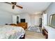 Bedroom boasting wood floors, floral bedding, ceiling fan, and light blue walls at 162 Carmelaire Dr, Carmel, IN 46032