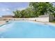 Inviting community pool with numerous lounge chairs and shaded areas, perfect for relaxation and recreation at 162 Carmelaire Dr, Carmel, IN 46032