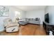 Cozy living room showcasing hardwood floors, a plush sofa, and natural light at 162 Carmelaire Dr, Carmel, IN 46032
